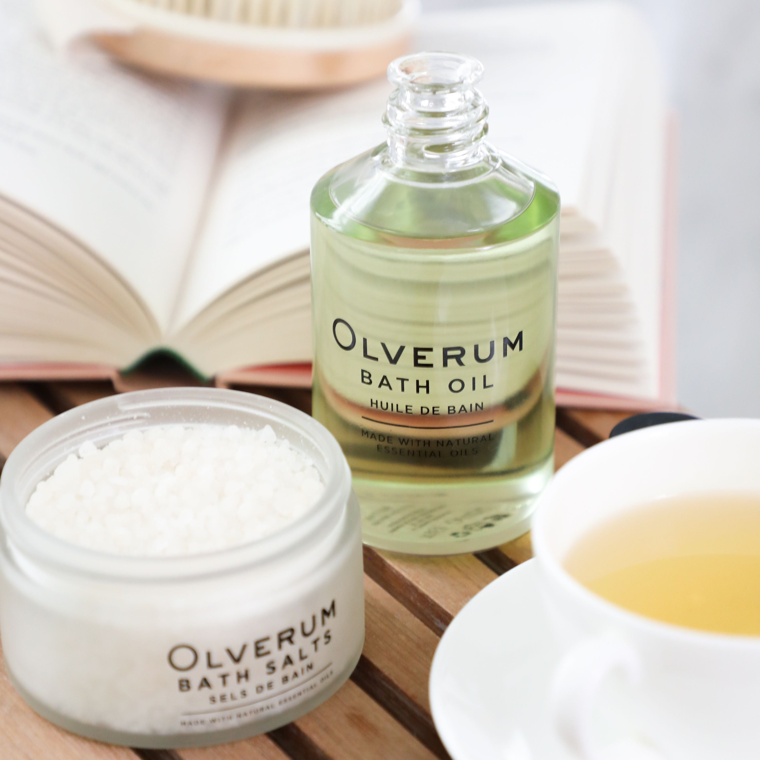 bottle-olverum-bath-oil-bath-salts-with-open-book-cup-of-tea