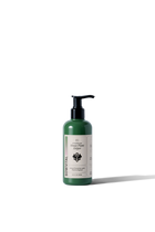 Green bottle with pump dispenser on a white background