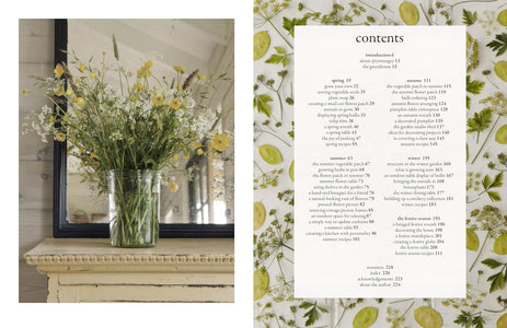 An open book or magazine spread showing a printed table of contents page on the right with floral border decoration, and a photograph of white flowers in a vase on a shelf on the left.