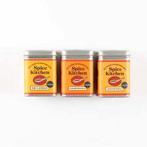 Three cans of Spice Kitchen spice blends on a white background
