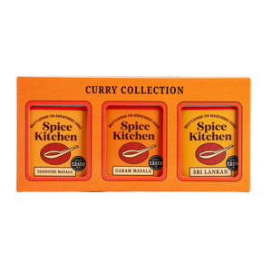 Orange box of Spice Kitchen Curry Collection with three spice packets inside.