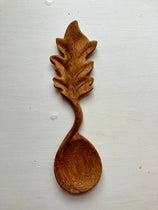 Leaf wooden handle spoon on white background