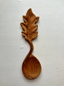 Leaf wooden handle spoon on white background