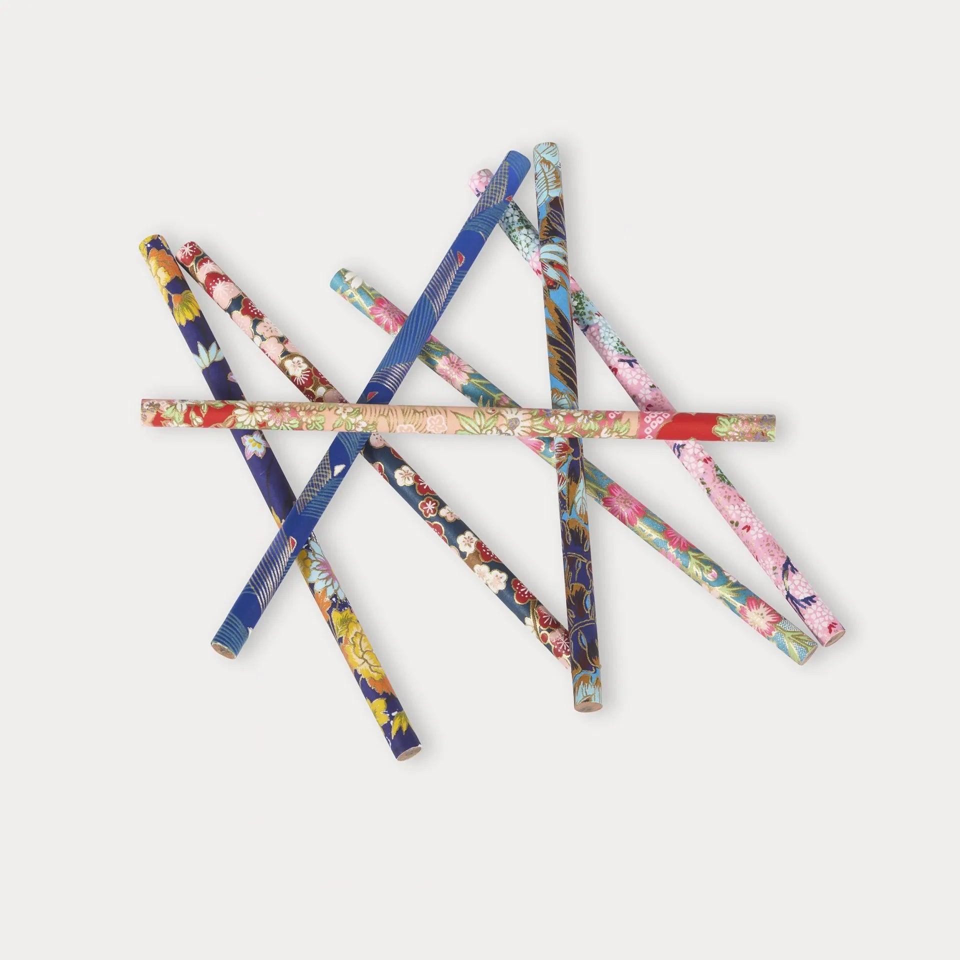 Set of colorful floral-patterned pens on a white background