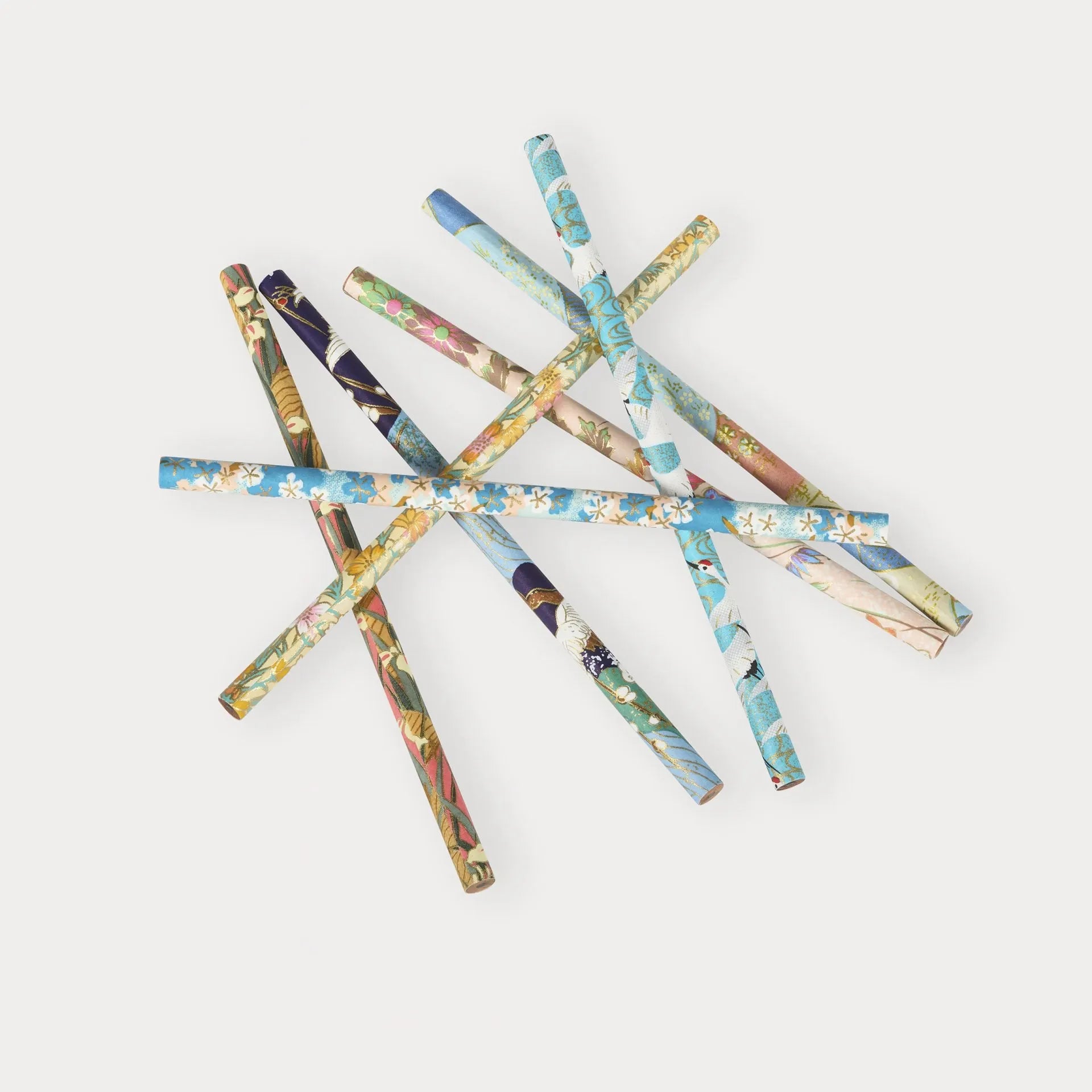 Decorative sticks with floral patterns arranged in a star shape on a white background