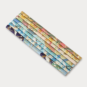 Set of colorful patterned paper rolls on a white background