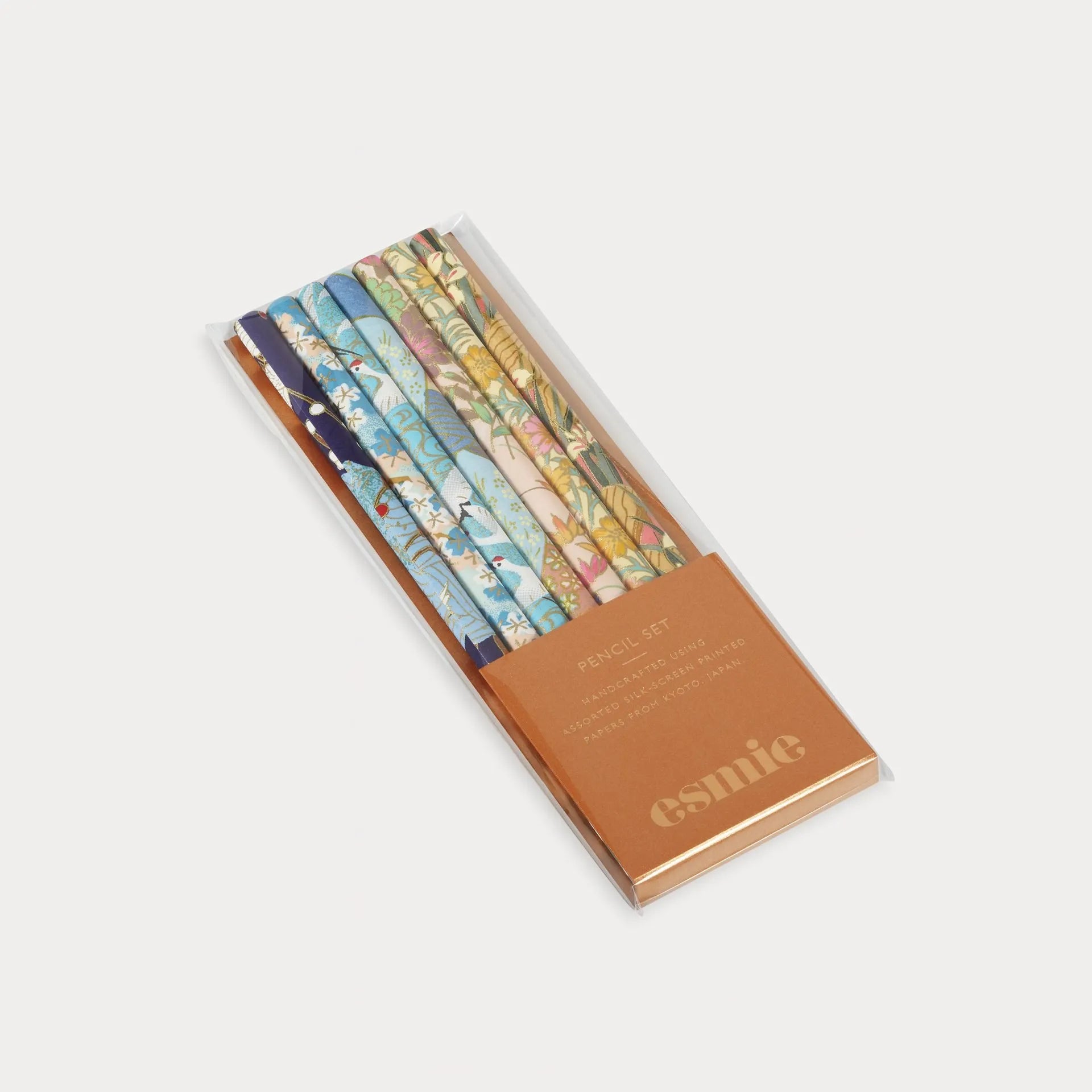 Set of colorful pencils in a branded box on a white background