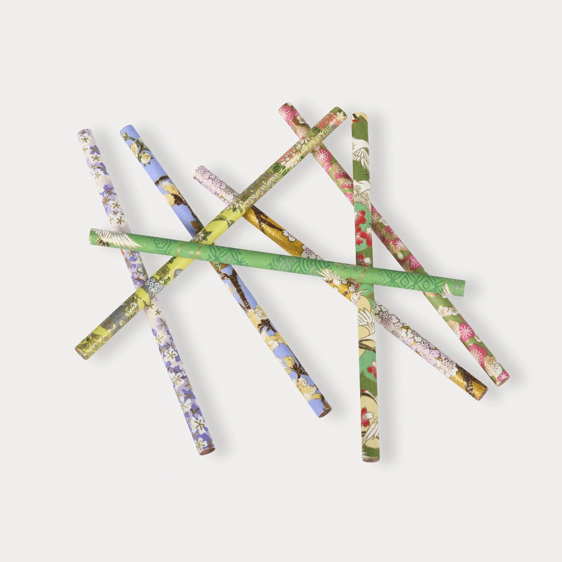 Set of floral-patterned pencils on a white background