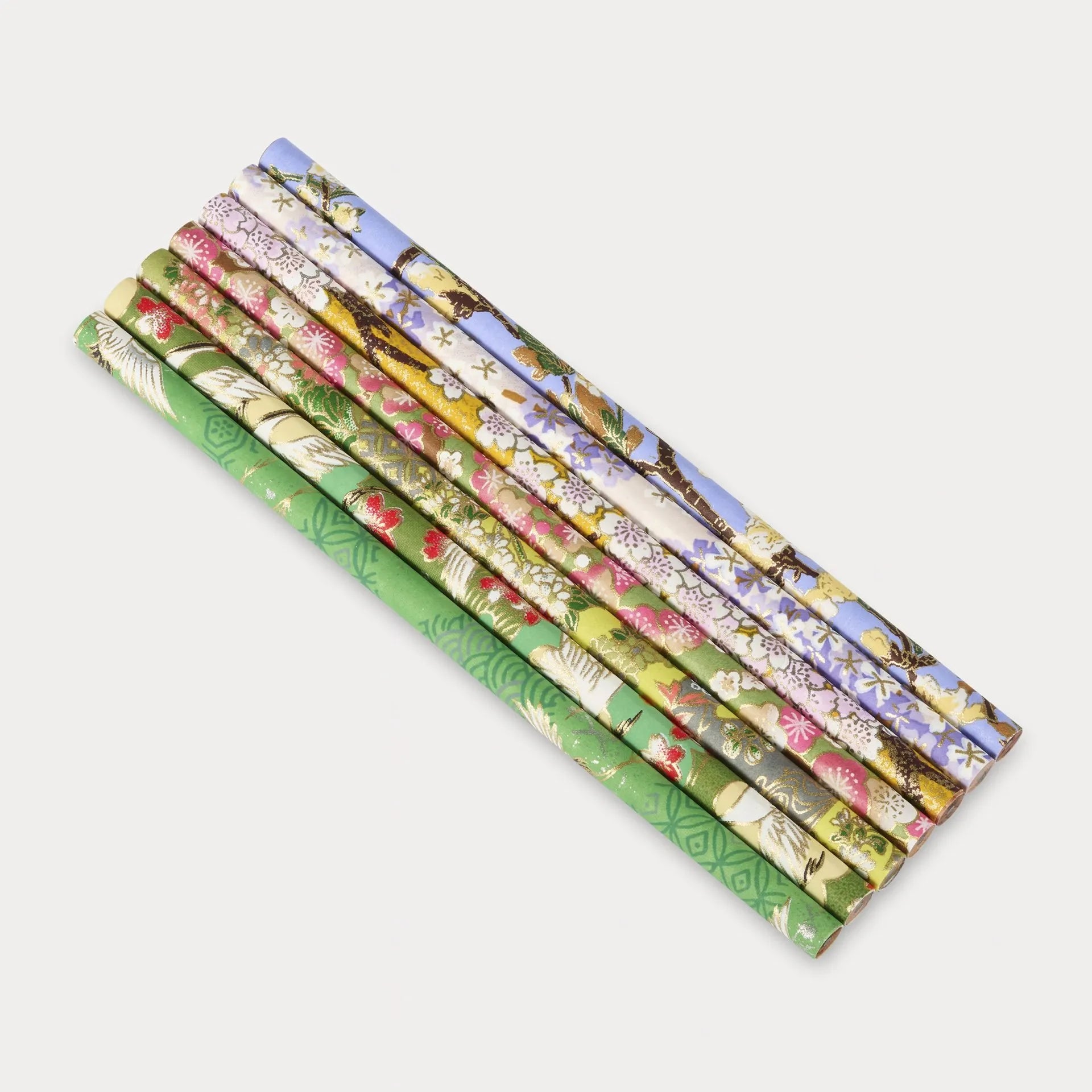 Set of colorful patterned paper rolls on a white background
