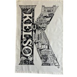 Tea towel with black and white design of Kelso, featuring landmarks and text.