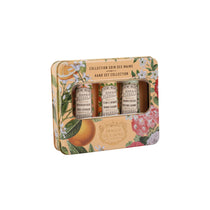 Hand care set with three bottles in a decorative box on a white background
