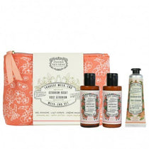 Set of skincare products including a bag, bottles, and a tube on a white background