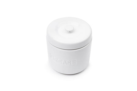 A white cylindrical jar with a matching screw-top lid, featuring the brand name 'MIRACLE' embossed on the front, set against a plain white background.